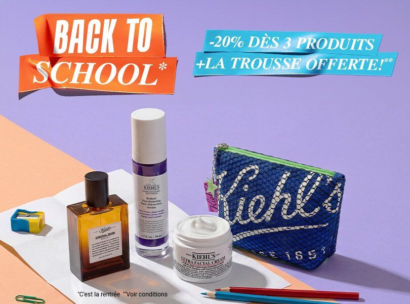 trois produits kiehl's et une trousse bleue poses sur une table orange avec un fond violet