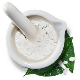Mortier et pilon avec une poudre blanche sur une feuille verte, illustrant de l'arigile blanche amazonienne