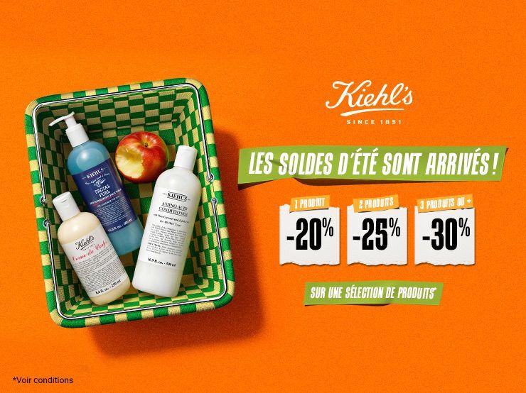 un panier vert et jaune avec a l'interieur une pomme et trois produits de soin de la peau kiehl's sur un fond orange