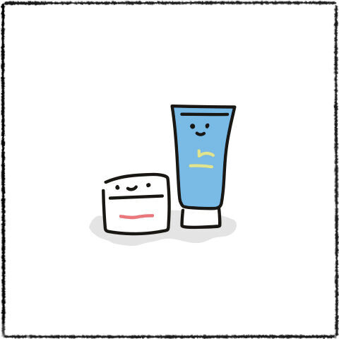 Deux tubes de creme avec des visages souriants, un pot blanc et un tube bleu.