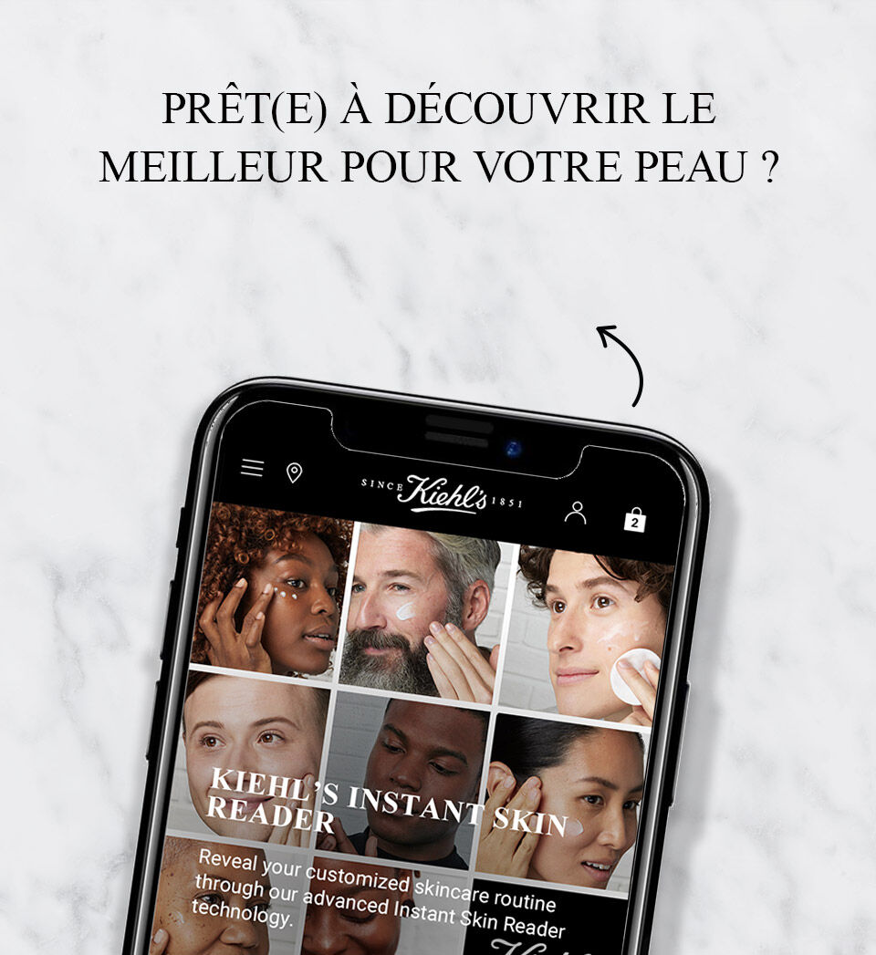 Image d'un telephone affichant un site web avec des options de soins pour la peau, accompagne d'un code QR et du texte incitant a explorer les produits Kiehl's.