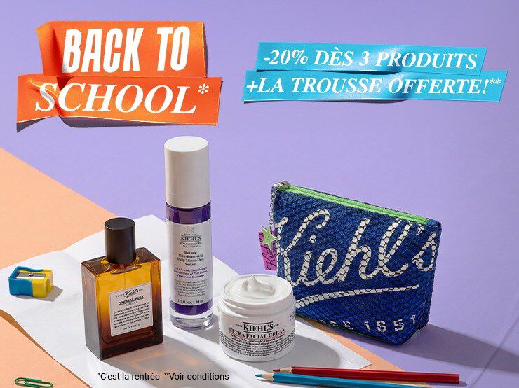 trois produits kiehl's et une trousse bleue poses sur une table orange avec un fond violet